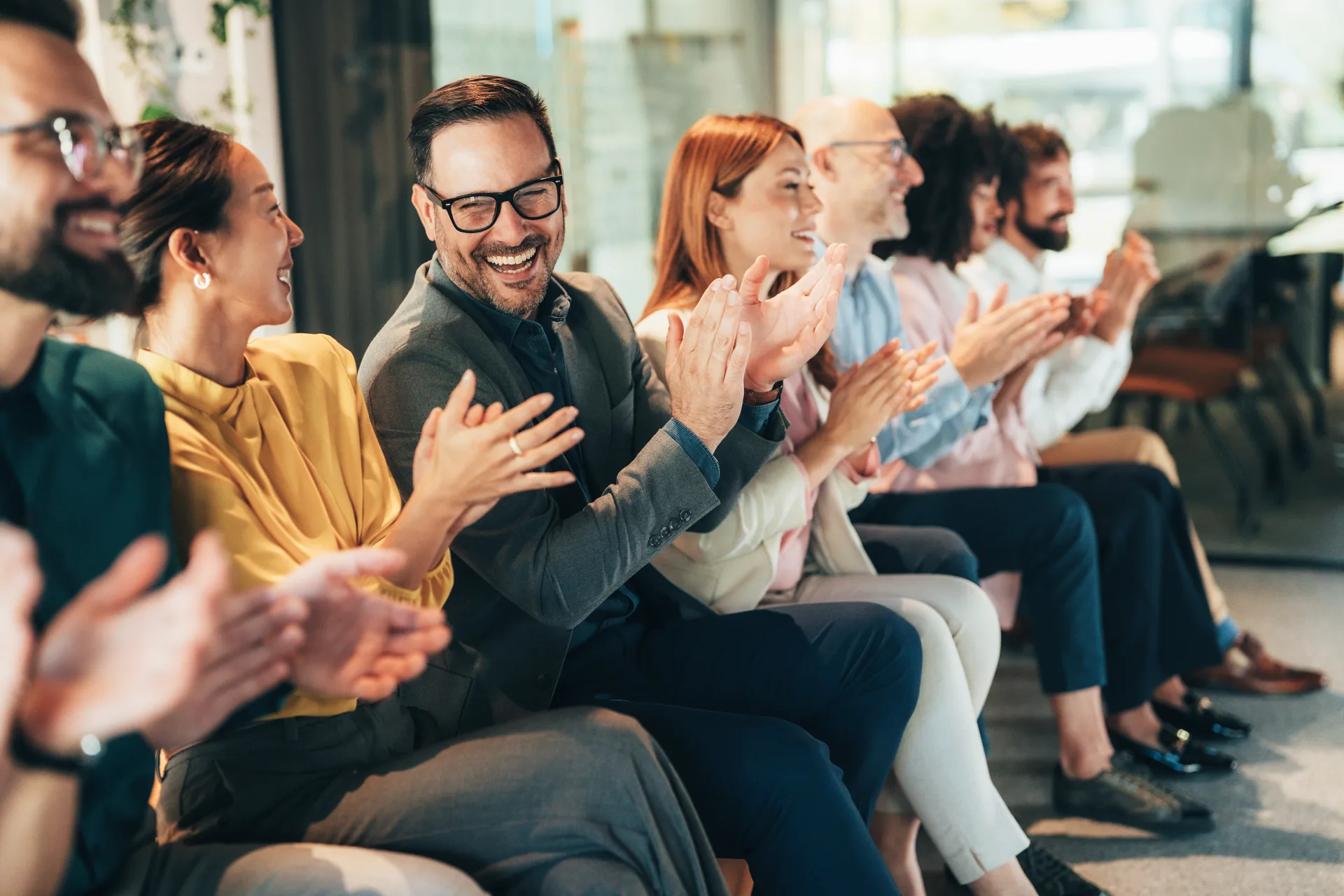 A warm, engaged audience applauding at a workshop